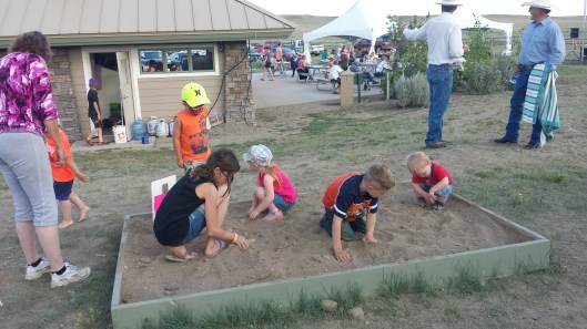 Digging in the treasure sand at Grasslands National Park's Sleep Under the Stars Party